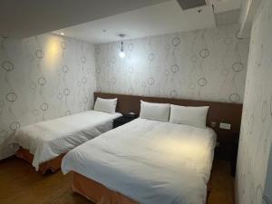 Postel nebo postele na pokoji v ubytování 瑾旅南西館 Gininn NanXi