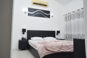 a bedroom with a bed with a black headboard at Fun City Water & Theme Park in Dar es Salaam +105 photos