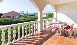 a porch with a table and chairs on a balcony at Apartment Nin 531 in Nin