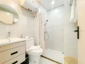 a bathroom with a shower and a toilet and a sink at Landmark Vientiane Life Center in Vientiane +33 photos