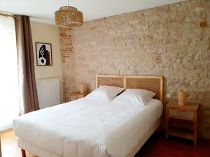 Postel nebo postele na pokoji v ubytování Gîte Le Pavillon Vougeot - Romanée - SPA