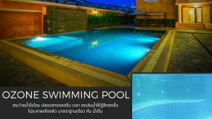 a swimming pool with blue lighting in a house at Grandsmile Wellness Resort in Pattaya Central