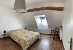 a bedroom with a bed and a table and a chair at La perle des Lacs in Dompierre-sur-Mont +33 photos