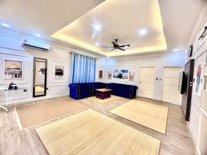 a living room with a blue couch and a ceiling at D’Lehans Homestay in Papar