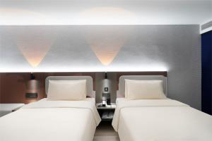 Cama o camas de una habitación en Atour Light Hotel Nanjing Chengxin Avenue Subway Station