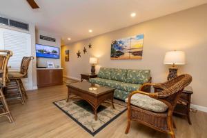 a living room with a couch and a table at Kihei Beach Resort 608 in Kihei