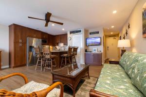a living room with a couch and a kitchen at Kihei Beach Resort 608 in Kihei