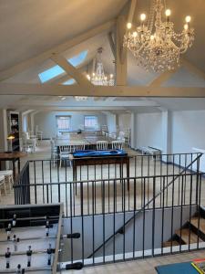 a large room with a chandelier and tables and chairs at Maison entière de 2 à 6 personnes in Sées +27 photos
