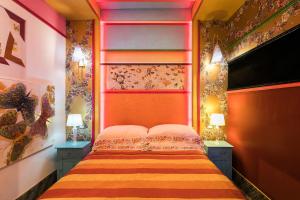 a bedroom with a bed with two night stands and two lamps at Appartamenti MarcoAurelio49 in Rome +165 photos