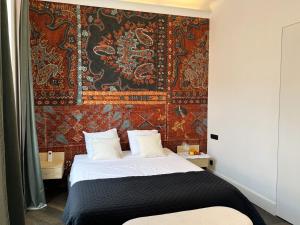a bedroom with a bed with a tapestry on the wall at Luxury Cannes in Cannes