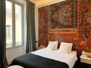a bedroom with a bed with a tapestry on the wall at Luxury Cannes in Cannes