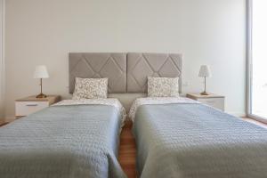 Ένα ή περισσότερα κρεβάτια σε δωμάτιο στο Cond Bayline - Breeze Wellness & Living - Bacalhau - BY BEDZY +23 φωτογραφίες