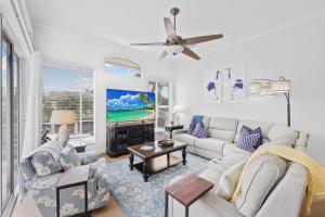 a living room with a couch and a tv at Alluring waterfront home with W exposure, pool/dock in Marco Island
