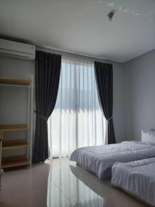 Ένα ή περισσότερα κρεβάτια σε δωμάτιο στο Arleen Homestay