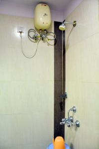 a shower in a bathroom with an orange ball on the wall at hotel in nova in Hyderabad