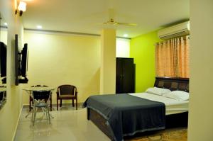 a bedroom with a bed and a table in it at hotel in nova in Hyderabad