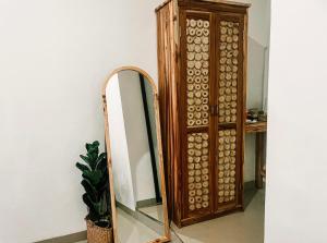 a wooden mirror next to a wooden cabinet at Nusa Penida Homestay in Nusa Penida
