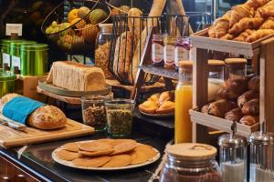 a display of bread and pastries and other baked goods at Mercure Paris Butte Montmartre Basilique in Paris