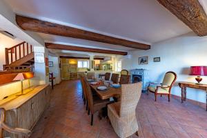 a dining room with a table and chairs at Domaine la Yole Wine Resort in Vendres