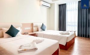 a hotel room with two beds and a couch at Landmark Vientiane Life Center in Vientiane