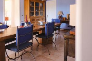 a dining room with blue chairs and a wooden table at Blu di Prussia in Laureana Cilento