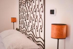 a bedroom with a bed and two lamps and a wall at Blu di Prussia in Laureana Cilento
