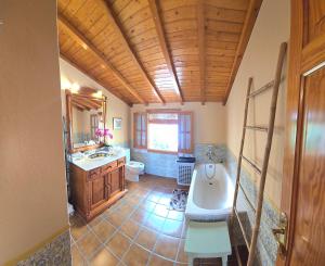 a bathroom with a tub and a toilet and a sink at Charming Villa in Carratraca, Malaga - 4 Bedrooms, Sleeps up to 8 Guest BY NAMASTE ELITE in Carratraca +51 photos