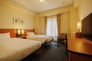 Postel nebo postele na pokoji v ubytování Hotel Monterey Sendai