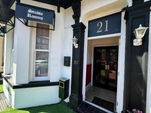 a store front with a sign that reads sutton shops at The Paradise Guest House in Great Yarmouth