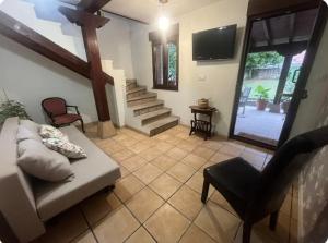 a living room with a couch and a chair at Las lastras 24 in Queveda