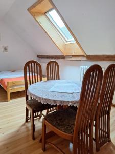 a dining room with a table and four chairs at Folwark in Stronie Śląskie +37 photos