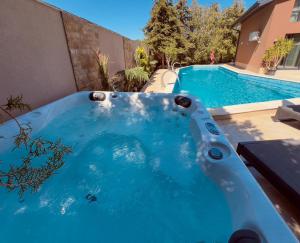 a swimming pool with a hot tub in a backyard at Pino - Villa, Casa, Cucina е Terrazza in Albena