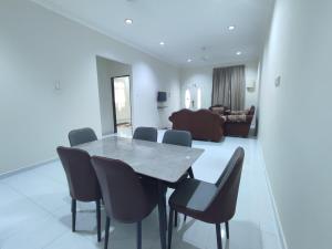 a dining room with a table and chairs at CASA ADELIA GUESTHOUSE 3b in Cukai