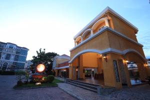 a building on a street in a city at Grandsmile Wellness Resort in Pattaya
