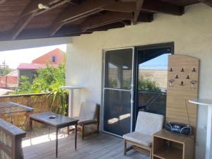 a patio with two chairs and a table on a balcony at Gogo’s house in Mangalia