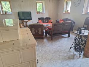 a living room with a couch and a tv at Folwark in Stronie Śląskie