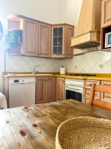 a kitchen with wooden cabinets and a wooden table at Casa Picón in Tinajo +10 photos