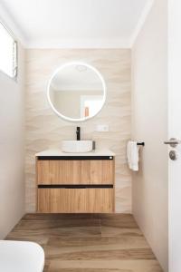 a bathroom with a sink and a mirror at Dialez Holidays - Rebecca in Playa de las Americas