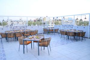 a restaurant with tables and chairs on a roof at Pravasa hotel Indore in Indore