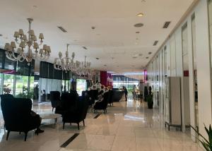 a lobby with chairs and tables in a building at Budget Suite Paranaque in Manila +31 photos