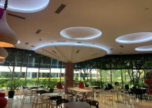 a restaurant with tables and chairs in a building at Budget Suite Paranaque in Manila