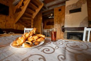 a table with a plate of croissants and a glass at Całoroczne Domki "Stokrotka" in Solina +111 photos