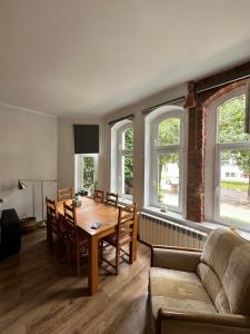 a living room with a table and a couch at Mazurski klimat in Ełk