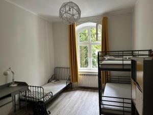 a room with two bunk beds and a window at Mazurski klimat in Ełk