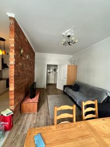 a living room with a couch and a table at Mazurski klimat in Ełk +4 photos