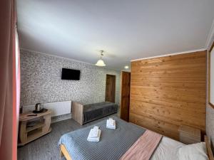 a hotel room with a bed and a couch at Good House Yaremche in Yaremche