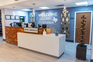 a welcome desk in a store with a welcome home signage at Hampton Inn & Suites Denton in Denton