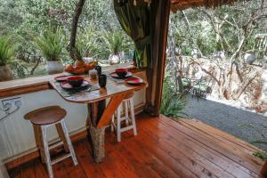 a table on the porch of a cabin with a view at Ol Losowan House and Cottages in Nairobi