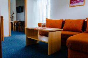 a living room with a couch and a table at Penzion Oaza Prievidza in Prievidza