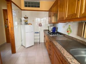 a kitchen with a white refrigerator and a sink at Apartamento Puerto Tazacorte in Puerto de Tazacorte